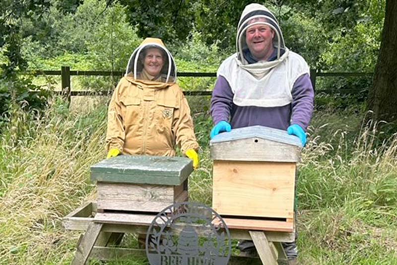 jennifer standing by a beehive