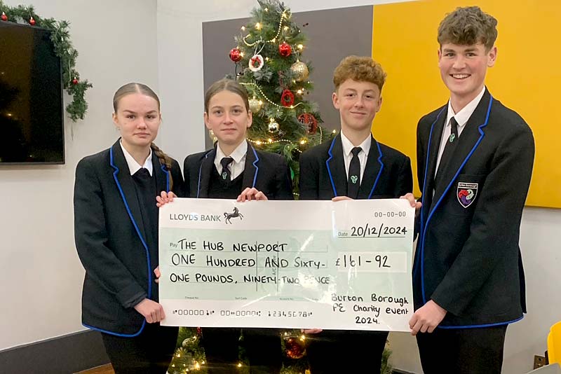 students holding cheque for youth project